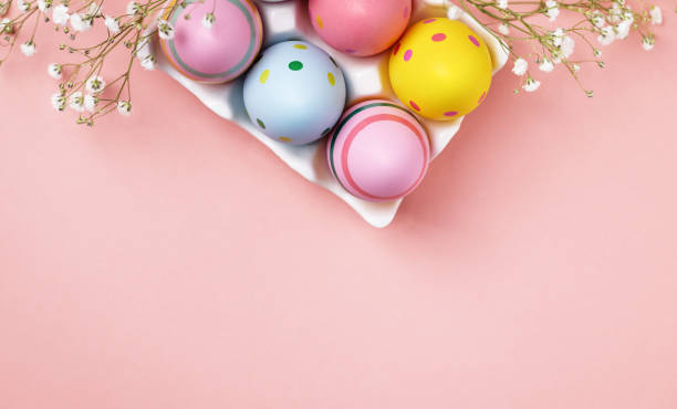istock Colourful Easter eggs and gypsophila flowers background. 1473043378
