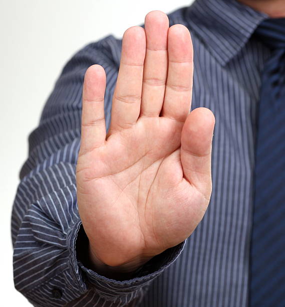 istock A man in a shirt holding his hand in a stop position 147304398