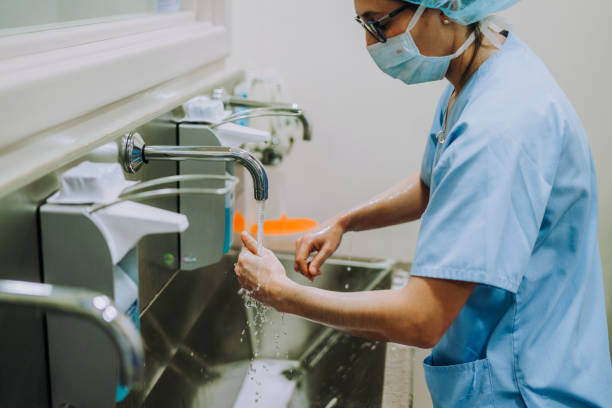 istock Unrecognizable doctor washing hands before operating 1473044026