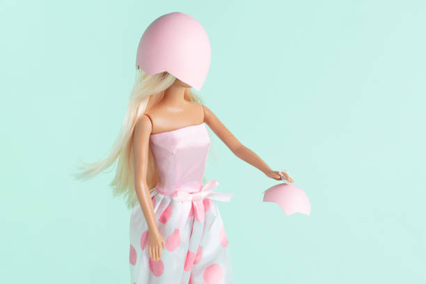 A young Caucasian female in a stylish pink dress is standing against a vibrant purple background. She is expressing a disappointed emotion with her hand on her hip and looking to the side.