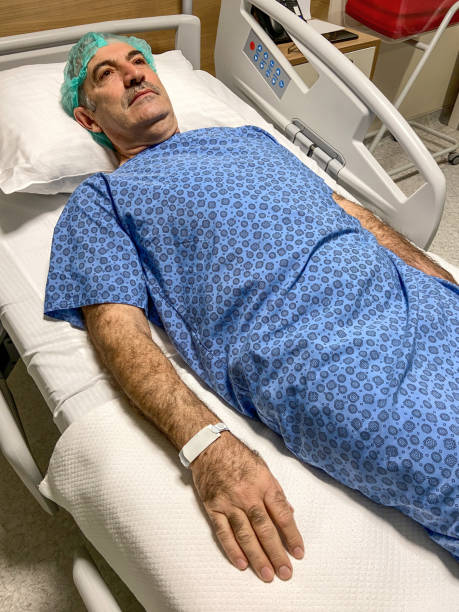 istock Patient ready for surgery operating. Senior man lying down on hospital bed for surgery in hospital ward 1473048619