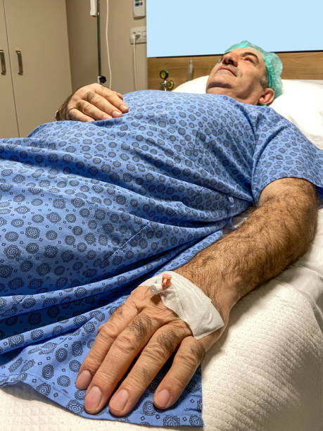 istock Patient ready for surgery operation. Senior man lying down on hospital bed for surgery in hospital ward 1473048675