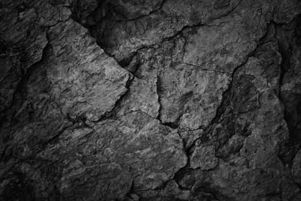 istock Cracked rock texture. Black white stone background. Grunge. Dark gray rough surface. 1473053829