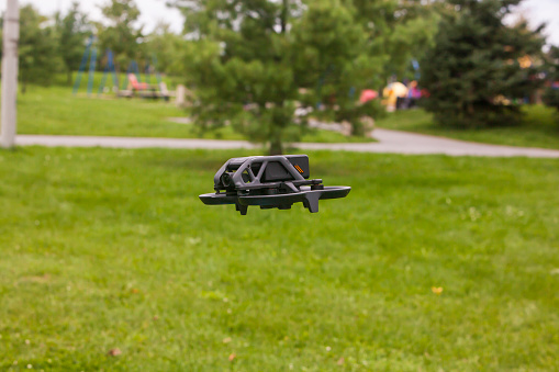 Orleans, Ontario, Canada - 09/11/2022:   DJI Avata Drone flying above the grass near playground.