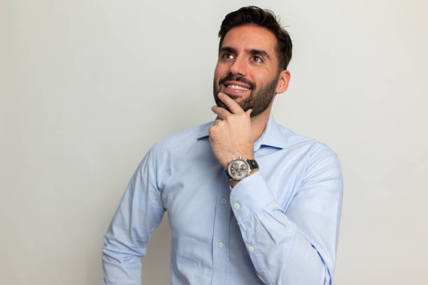 istock Smiling handsome man with laptop on gray background 1473057023