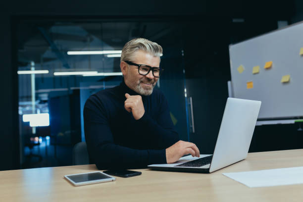 istock Mature successful boss working inside modern office, senior gray haired businessman at work working with laptop smiling and happy investor happy with achievement 1473058282