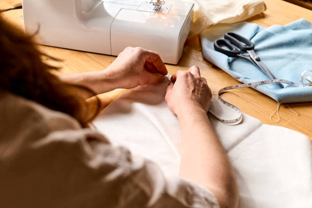 istock Seamstress basting and sewing in a small studio. Sartorial clothes. Fashion studio, tailoring, handmade clothing concept. Slow fashion. Conscious consumption. 1473059680