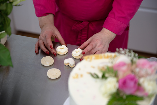 Confectioner decorates a birthday cake