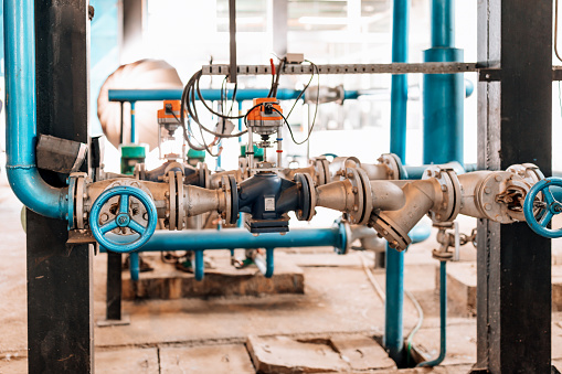 A system of pipes and valves in a heating plant.