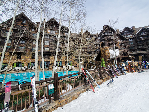 People and skis at Beaver Creek, Colorado, USA- March 8, 2023: Bachelor Gulch base area. Beaver Creek ski resort, Colorado.
