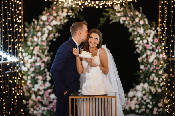 istock newlyweds happily cut and taste the wedding cake 1473061354