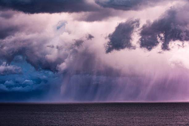 Tornado waterspout in the ocean with heavy rain, lightning and dark dramatic sky, clouds. Extreme weather scene in Australia.