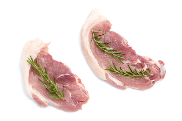 istock Pork meat with rosemary on white background. 1473062488