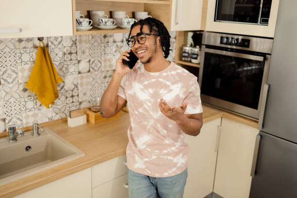 istock Young African American making a phone call at home 1473062787