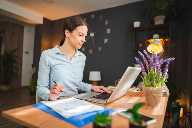 istock Ambitious young woman sitting at desk working at home 1473063402