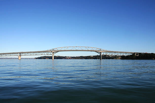 Auckland Harbour Bridge Auckland Harbour Bridge viewed from the ocean on a bright sunny morning Waitemata Harbor stock pictures, royalty-free photos & images