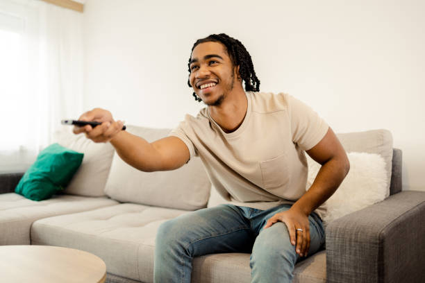 istock Man enjoying on the sofa, watching TV 1473065171