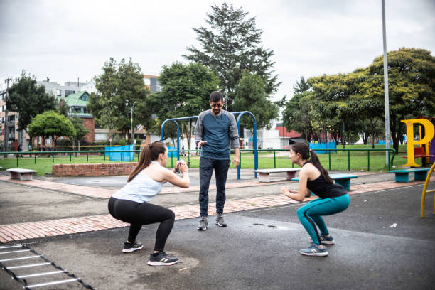 istock Coach giving a squat training outdoors 1473065232