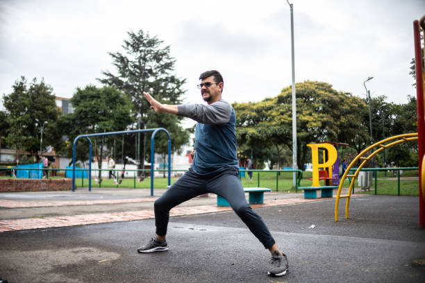 Mature man doing a fight stance outdoors