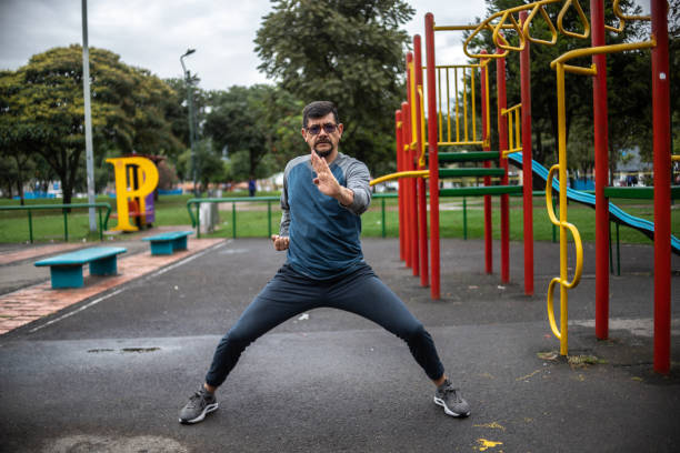 istock Mature man doing a fight stance outdoors 1473065253