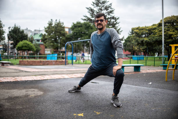 istock Mature man stretching outdoors 1473065255