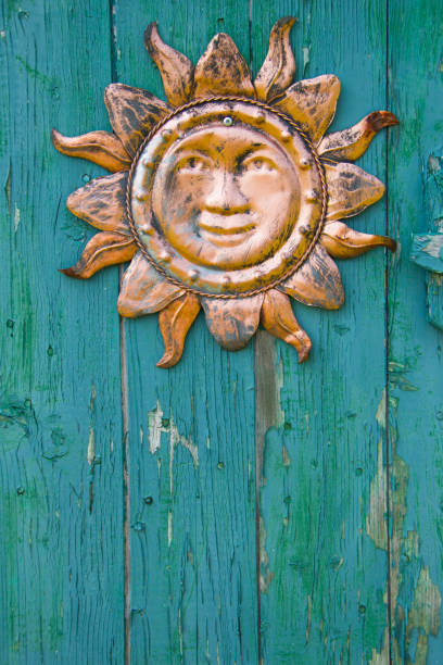 istock Happy sun decoration on an old door 1473065939