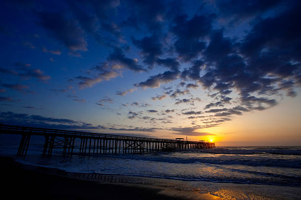 istock Intense colors sunrise at beach pier 147306657