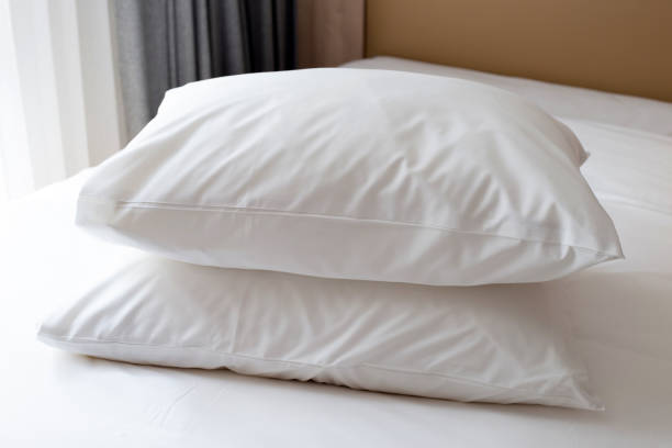 istock Bed with white pillows in bedroom 1473070015