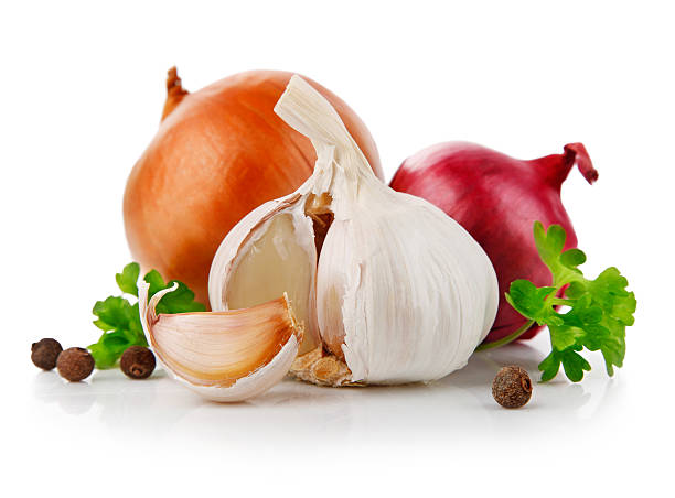 Garlic and onions garnished with Presley and spice stock photo
