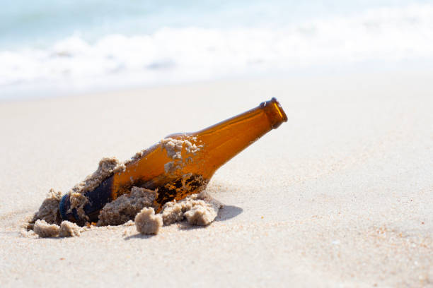 istock Glass bottle on the beach 1473070293