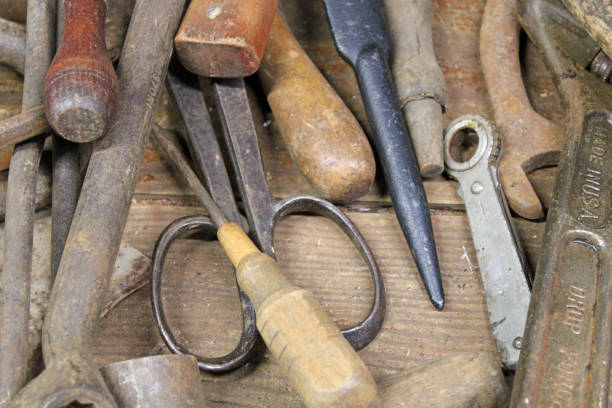 istock Antique tools jumbled on a wooden table at the antique stores 1473070294
