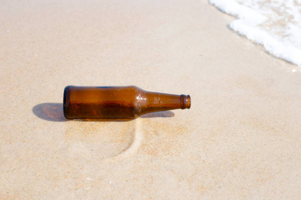 istock Glass bottle on the beach 1473070432