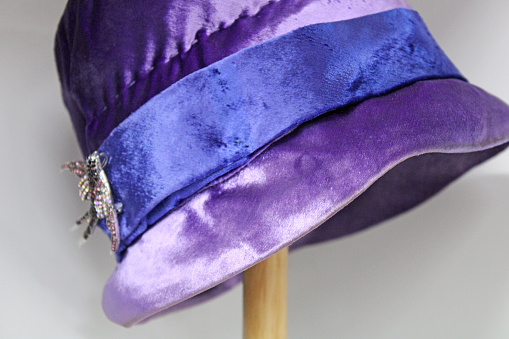 Antique purple/blue hat on hatstand at the antique stores
