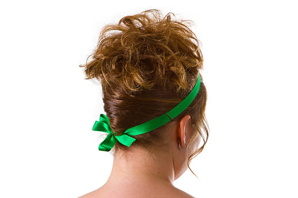 Young caucasian woman with an updo hair style on bright background