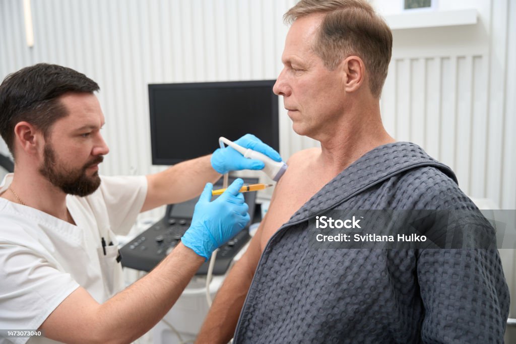 Doctor Sampling Calm Patient Going Through Biopsy Sampling Process Under Doctor Control ...