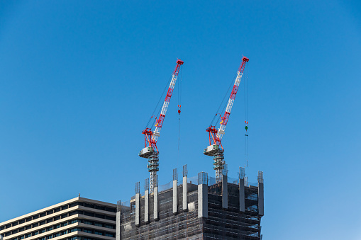 two tower cranes on construction site