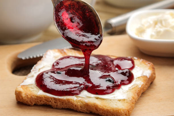 istock toasts with jam. fried crispy toast with red jam on a natural wooden table. breakfast. close-up 1473075732