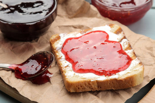 istock toasts with jam. fried crispy toast with red jam on a blue wooden table. breakfast. close-up 1473075744