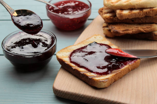 istock toasts with jam. fried crispy toast with red jam on a blue wooden table. breakfast. 1473075745