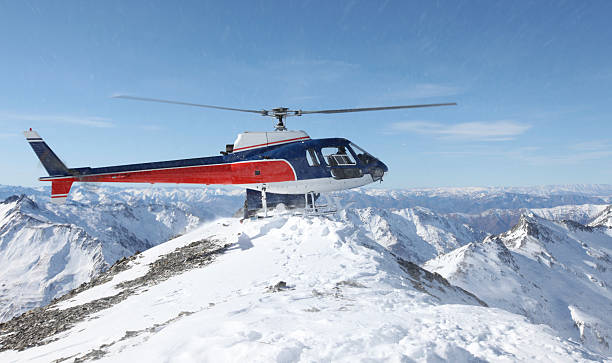 Heli-ski helicopter on mountain Ridge stock photo