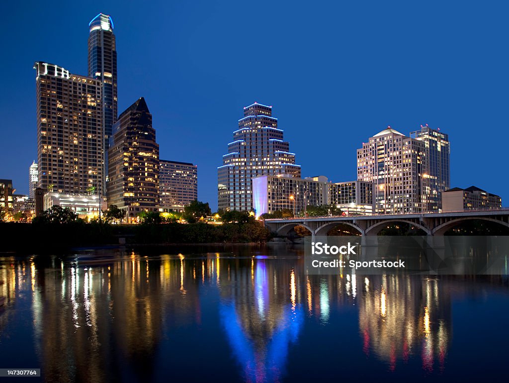 Austin Skyline Reflection On Lady Bird Lake Austin Texas skyline, Lady Bird Lake and Congress Avenue Bridge. This barrel-arched bridge with its open construction was built in 1910 and is home to millions of bats. Austin - Texas Stock Photo