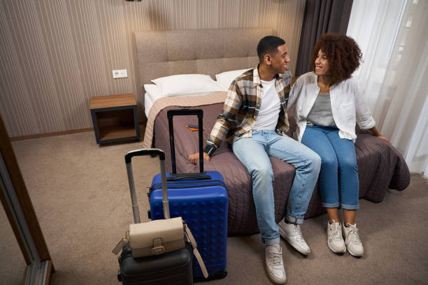 istock Happy newlyweds arrived at the hotel, around suitcases 1473077842