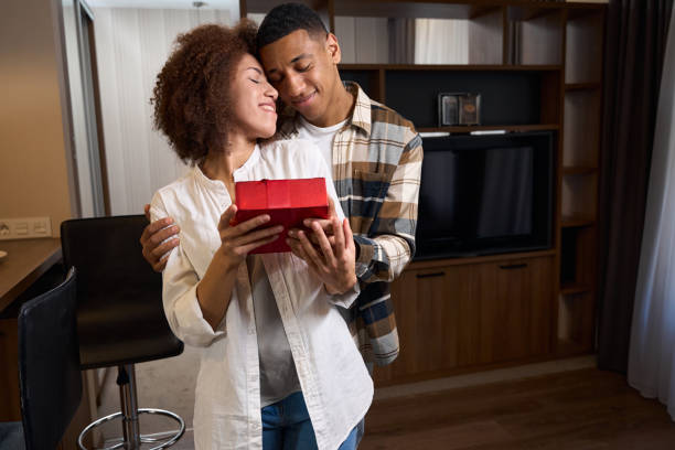 istock Multiracial young woman holds a red box in her hands 1473077890