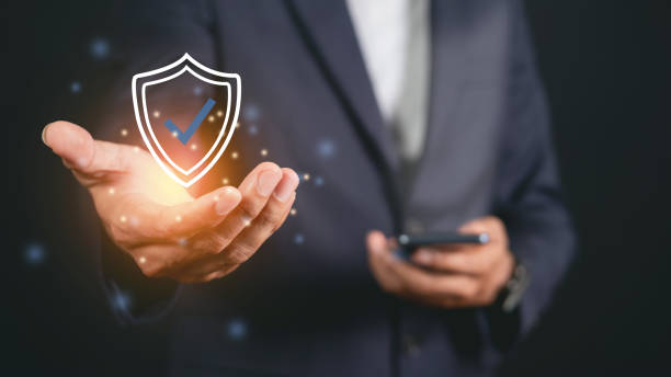 istock Businessman holding shield protective icon. Smartphone network security protection and data security concept, cyber security and hazard protection. 1473082743