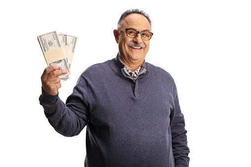 Mature man holding stacks of money and smiling isolated on white background