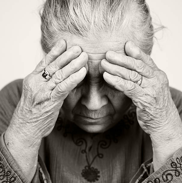 Sad old senior woman with health problems stock photo