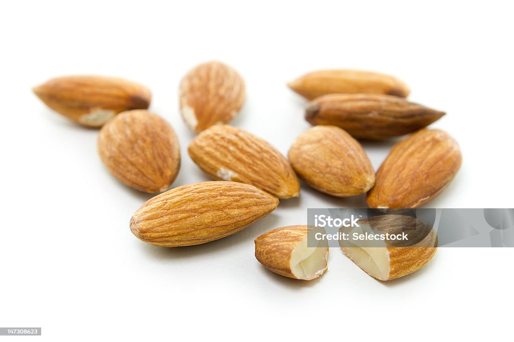 Almonds on white Many brown almonds isolated on white Almond Stock Photo