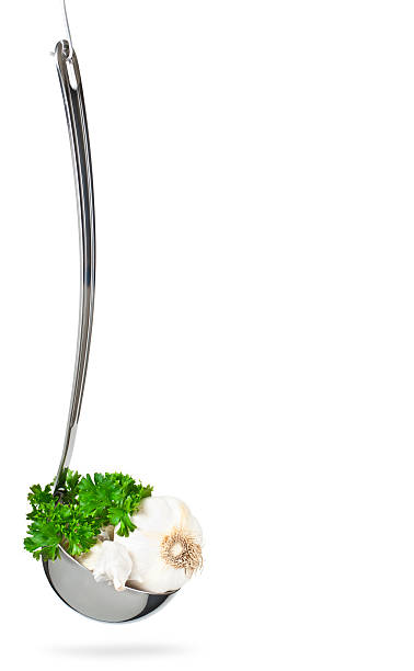 Garlic and parsley in ladle stock photo