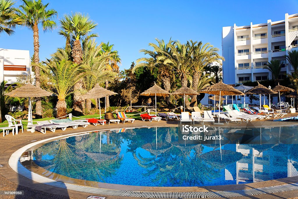 Swimming Pool. Resort swimming pool with empty lounge chairs in the morning. Tunisia Stock Photo