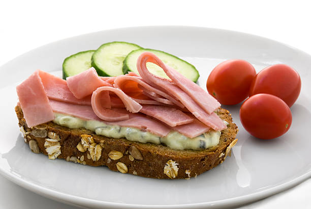 istock Bread slice with cucumber salad and ham 147309442